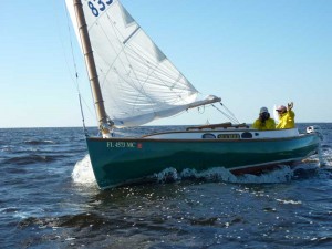 Catboat Willy waves to the mark set boat from his Marshall Sanderling catboat Marshall Sanderling Catboat